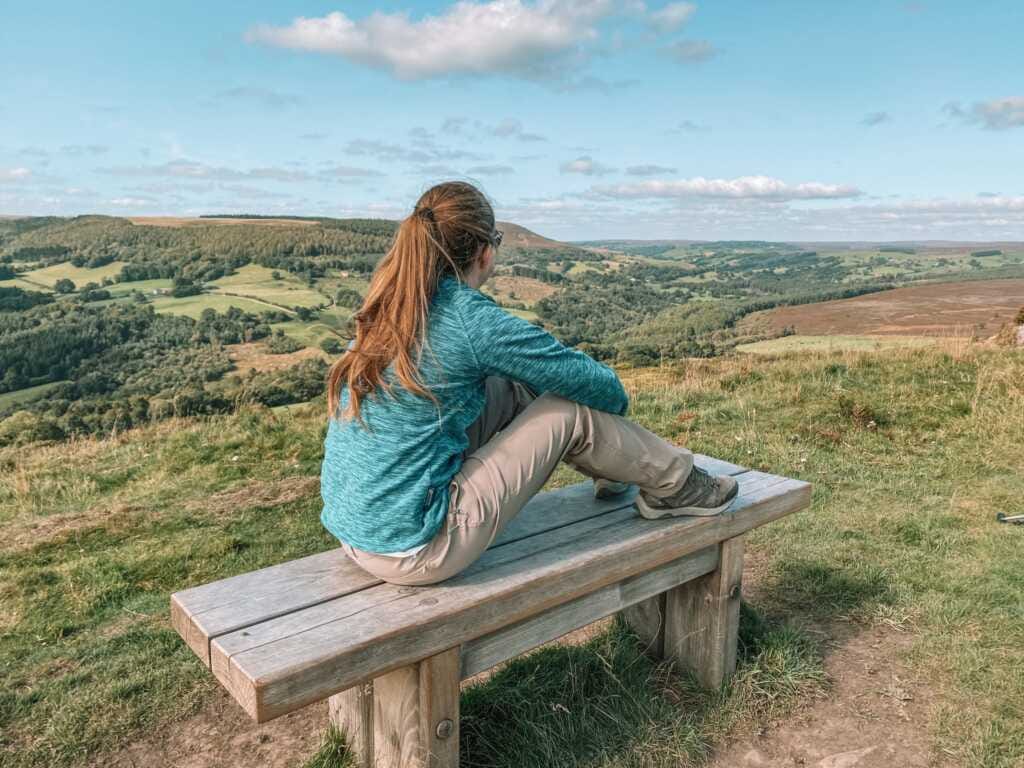 women sat on a bench in the country