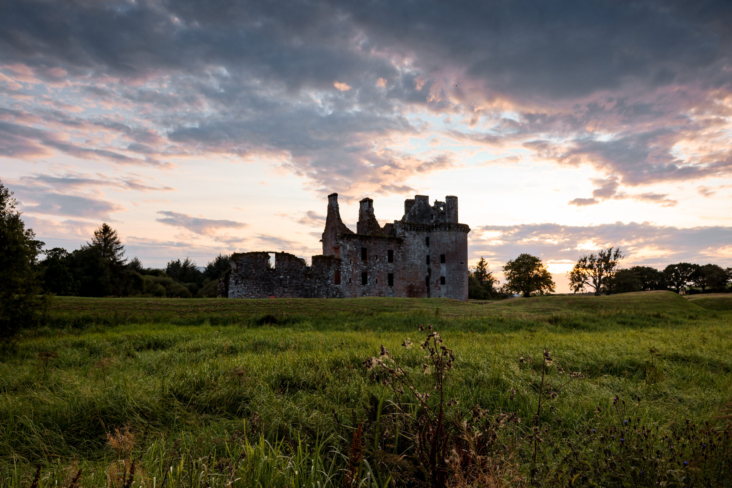 Sunset over Caerlaverloch Castle in Dumfries and Galloway, Scotland